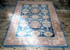 A mid 20th century Eastern style rug in pastel tones of blue, ivory, terracotta and green by
