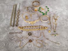 A jewellery box full of gold plated and yellow metal jewellery including chains, necklaces,