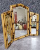 A faux bamboo three section table top mirror, with hinged side panes Height 55.5cm x width 65.5cm