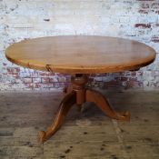 An early 20th century farmhouse pine dining / tavern table, bold turned support with carved shaped
