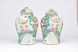 A pair of Chinese Famille Rose vases and covers