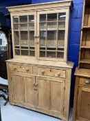 19th cent. Continental pine dresser/cabinet, the top with moulded cornice enclosed by two glazed