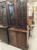 Early 20th cent. Mahogany two part bookcase, the thirteen pane glazed doors above two blind doors on