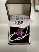 Jewellery: Yellow metal ring set with an oval synthetic ruby. Tests as 18ct gold. Size of ring J.