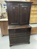 18th cent. Oak cupboard chest of drawers with two panelled doors and two shelves over a chest of two