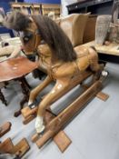20th cent. Palamino rocking horse leather saddle on a pine base.
