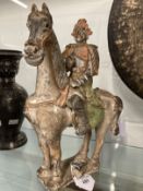 Chinese: Tang style carved and polychromed horse and rider, small section of rider's leg broken