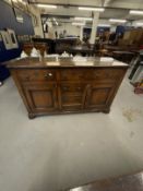 19th cent. Sideboard three drawers above two door cupboard with a central bank of false drawer