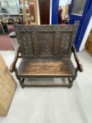 17th cent. Style oak settle with heavily carved decoration dated 1695 to the top rail. 39ins. x
