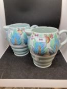 Clarice Cliff Newport Pottery moulded jugs decorated with a band of leaves and fruit, green
