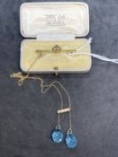 Jewellery: Yellow metal in the form of a 1½ins. bar brooch, at the centre is a flower set with an