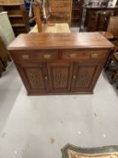Early 20th cent. Hardwood cupboard with two drawers above a central panel flanked by two doors all