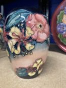 20th cent. Ceramics: Moorcroft ovoid shaped vase in the Honeysuckle pattern on pink and blue ground,
