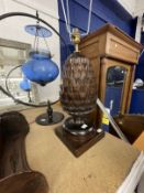 20th cent. Pineapple lamp, blue glass in a hoop lamp, hanging wall cabinet and a silvered mirror.