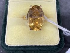 18ct gold ring set with an oval cut golden topaz, estimated weight of 9.00ct. Weight 8.2g.