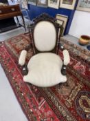 Early 20th cent. Mahogany open armed upholstered chair with carved top rail, scroll arms on turned