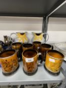 Ceramics: Poole pottery jugs decorated with sunflowers, a pair (½ins) and Arthur Wood mugs decorated
