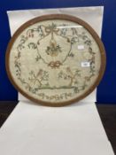 19th cent. Silk sampler depicting birds in trees surrounded by a laurel of rosebuds, forget-me-nots,
