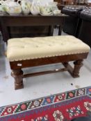 20th cent. Walnut duet piano stool with cream leather top, turned wooden knobs to the sides to