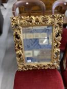 Late 19th cent. Small Florentine style carved and gilt mirror with bevelled plate. 22ins. x 18ins.
