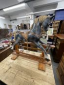 20th cent. Grey rocking horse with glass eyes, horsehair mane and tail on a pitch pine base.