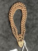 Jewellery: Yellow metal graduated double row curb link bracelet with padlock fastener and safety