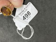 Jewellery: Yellow metal ring claw set with an oval cut citrine, tests as 9ct gold. Ring size P.