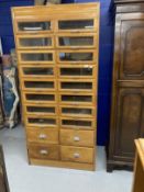 Post-war haberdasher's shop display with sixteen glazed drawers above four others, all with chrome