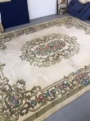 Carpets & Rugs: British made ivory ground woolen carpet with central floral decoration with a