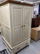 20th cent. Two door wardrobe with moulded oak cornice above two cream painted doors above a single