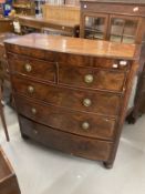 Early 19th cent. Mahogany bow front chest of two over three drawers with a cross banded top, round