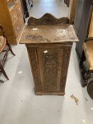 20th cent. Carved oak pot cupboard, mahogany standard lamp and oval mirror.