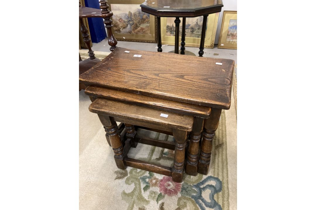 20th cent. Oak nest of three tables with turned legs and cross stretchers. Largest 18¾ins. x 24ins.