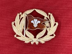 Badges: Gaunt of London gilt cap badge inset with red enamel and Prince of Wales feathers,