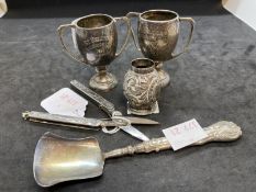 White metal and steel folding scissors the handles with relief decoration of flowers and a central