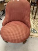Victorian upholstered nursing chair on turned legs to the front with castors. 31ins. x 25ins.