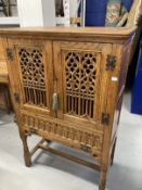 20th cent. Gothic style oak larder cupboard with two pierced and carved doors above a single fall,