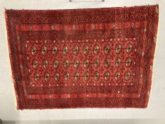 Carpets & rugs: 19th cent. Turkman rug, red ground with a central panel containing forty guls,