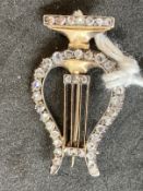 Jewellery: Yellow metal brooch in the form of a lyre set with forty-two rose cut diamonds, estimated