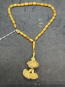 Jewellery: Islamic prayer beads consisting of (33) butterscotch amber beads with a drop at the
