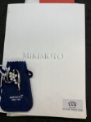 Jewellery: White metal open scroll brooch by Mikimoto set with eight cultured pearls, size of pearls
