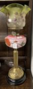 Victorian oil lamp black ceramic base, reeded brass column, pink glass reservoir decorated with