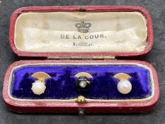 Jewellery: Yellow metal set of three collar studs, two set with a pearl and one with onyx and a rose