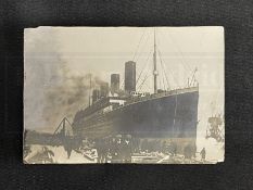 R.M.S. TITANIC: Sepia photograph of Titanic in Belfast, late 1911, the reverse reads 