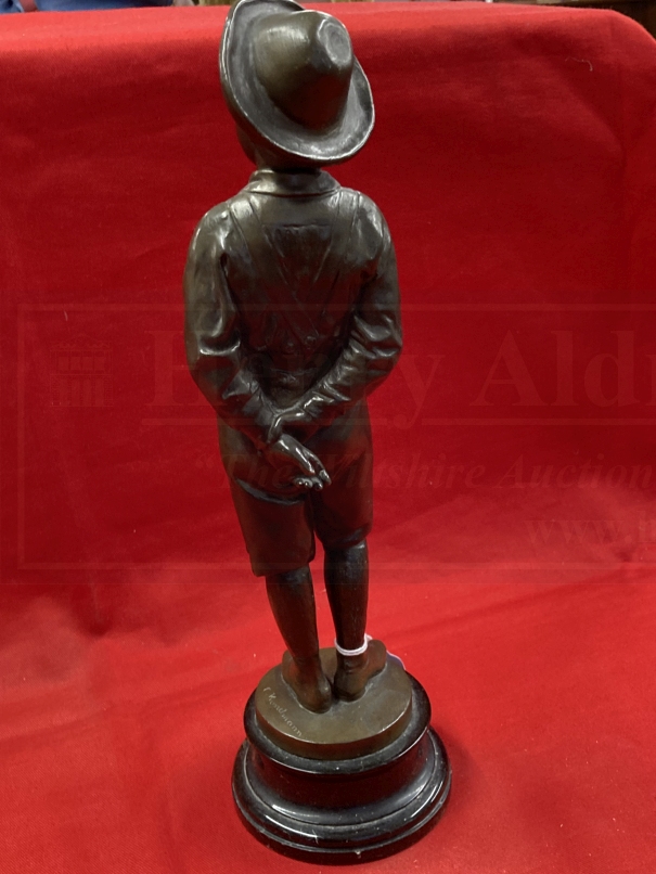 C. Kundonmann: Bronze figure of a boy smoking a Cheroot raised on a black marble base, signed C. - Image 3 of 4