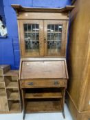 Arts and Crafts oak bureau bookcase of small proportions, leaded glass bookcase doors, the bureau