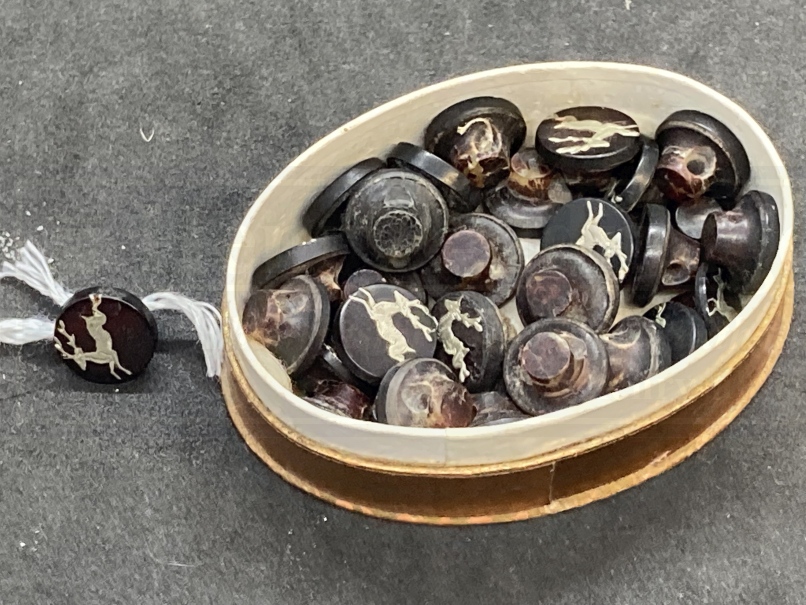 Objects of Virtu: 19th cent. Tortoiseshell buttons inlaid with silver stags ?ins, contained in an