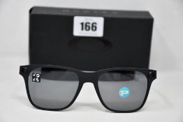 A pair of as new Oakley Apparition sunglasses Satin Black frame with Black iridium Polarized