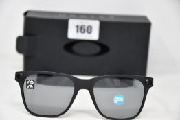 A pair of as new Oakley Apparition sunglasses Satin Black frame with Black iridium Polarized