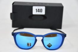 A pair of as new Oakley Pitchman R glasses matte translucent blue frame with Prizm Sapphire